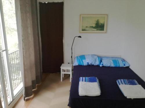 a bedroom with a bed with two pillows on it at Apartmani Stanislav in Petrovac na Moru