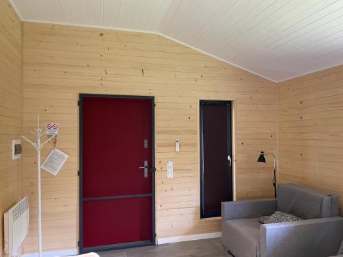 two red doors in a room with a couch at RedDoor Zator Lake Houses in Zator