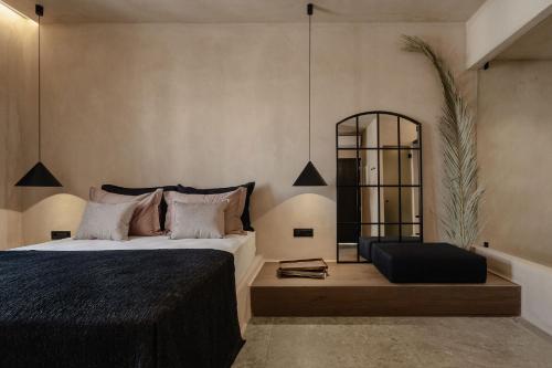 a bedroom with a large bed and a mirror at Emery Hotel in Naxos Chora