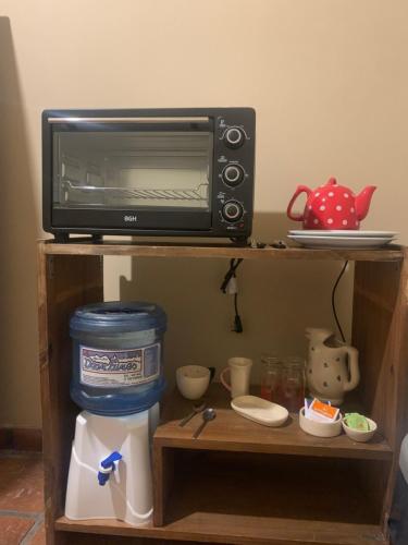 a microwave oven sitting on top of a shelf at La Palmera in Deán Funes