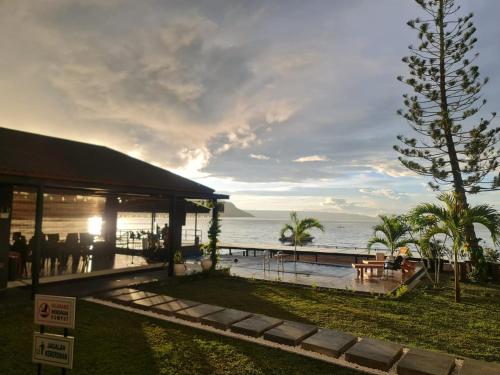 a view of a resort with the ocean in the background at PURNAMA BALIGE HOTEL in Balige
