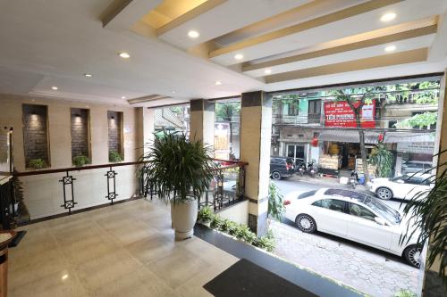 a lobby with a car parked in a parking lot at Gallant Hotel in Hanoi