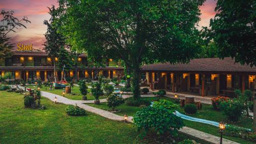a building with a garden in front of it at SIMI Luxury Suites in Plaka Litochorou