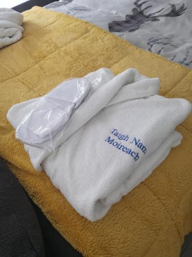 a pair of white towels sitting on top of a table at Beautiful studio chalet in the Highland in Inverness