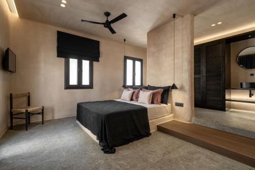 a bedroom with a bed and a ceiling fan at Emery Hotel in Naxos Chora