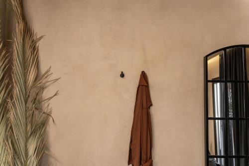 a brown umbrella hanging on the side of a wall at Emery Hotel in Naxos Chora