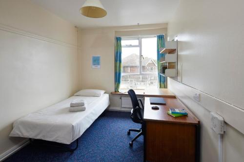 a room with a bed and a desk and a window at Ifor Evans Hall, Camden in London