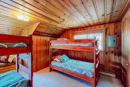 a bedroom with two bunk beds in a cabin at Weeping Willow Cabin in Hayden