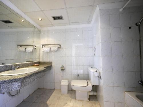 a white bathroom with a toilet and a sink at Happy Life Village Dahab in Dahab