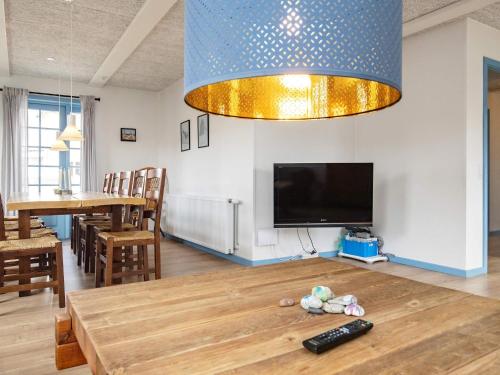 a living room with a table and a tv at 10 person holiday home in Marstal-By Traum in Marstal