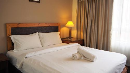 Łóżko lub łóżka w pokoju w obiekcie Leo Palace Hotel
