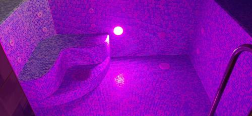 a pink light in a bathroom with a brick wall at Barda in Vorokhta