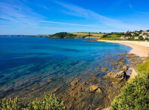 a view of a beach and the ocean at The Nest, Central Falmouth, 10 mins to the beaches and off street parking in Falmouth