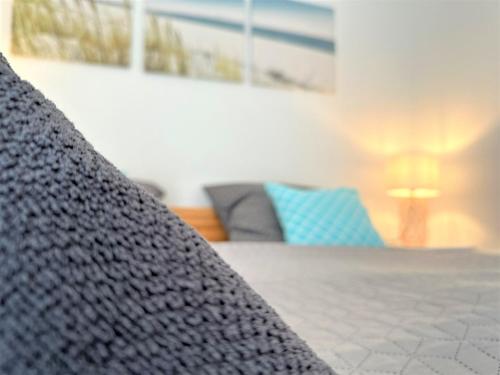 a close up of a bed in a room with a couch at COZY Apartment Bavarian Forest +POOL +SAUNA +NETFLIX in Zwiesel