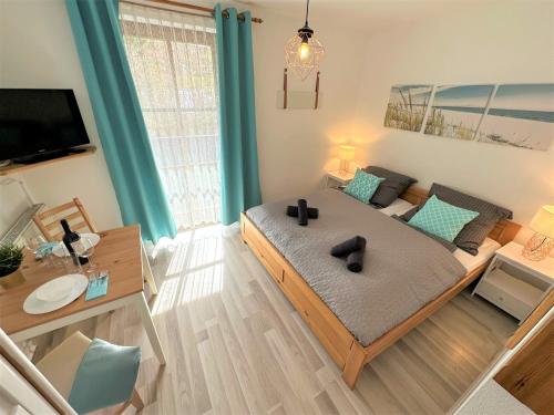 a bedroom with a large bed and a living room at COZY Apartment Bavarian Forest +POOL +SAUNA +NETFLIX in Zwiesel