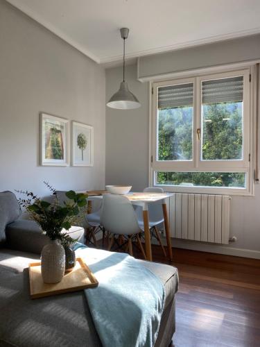 a living room with a couch and a table at Apartamento Playa Ostende ,Garaje incluido in Castro-Urdiales