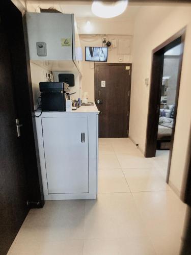 a kitchen with a white refrigerator in a room at Apartment In Mumbai City Centre in Mumbai