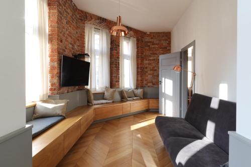 a living room with a couch and a tv at Central Apartamenty in Jelenia Góra