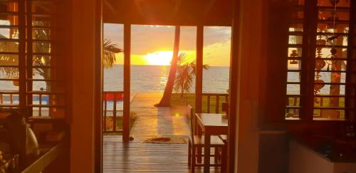 a room with a view of the ocean and the sunset at Lodge Villa MAYANKI in Dzamandzar