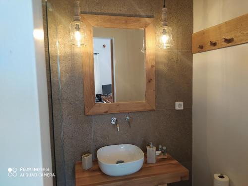 a bathroom with a sink and a mirror at Chaido Studios in Plaka Milou