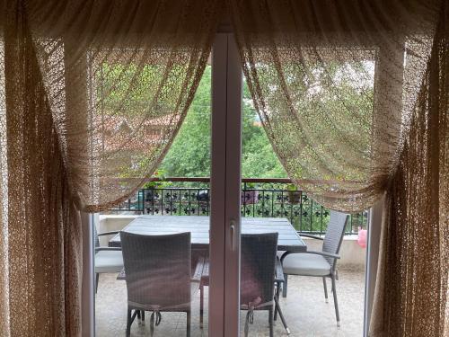 a view of a table and chairs from a window at Ralin Apart in Prizren