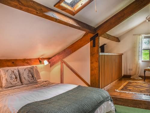 a bedroom with a bed in a room with wooden ceilings at The Shippon in Appletreewick