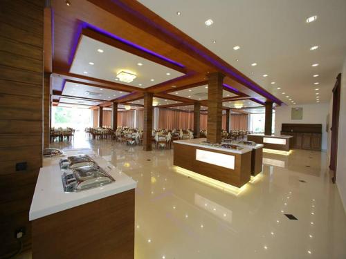 a large room with a kitchen and a dining room at Ruins Chaaya Hotel in Polonnaruwa