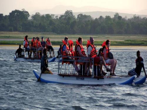 a group of people on a boat in the water at Ruins Chaaya Hotel in Polonnaruwa