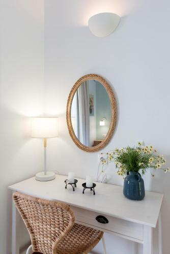 a white desk with a mirror and a lamp at Reana Elegant Apartments by Konnect, Barbati in Barbati