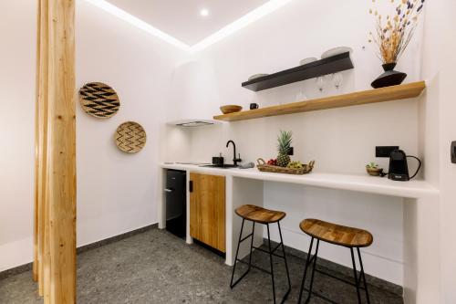 a kitchen with a counter and two stools at Naxian Secret in Naxos Chora