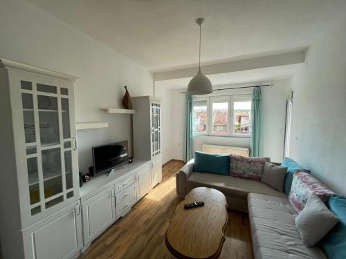 a living room with a couch and a table at ZOJA City Centre Apartments in Kavadarci