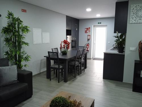 a kitchen and dining room with a table and chairs at Casa do Toucedo - Encanto da Natureza Caniçada / Gerês in Caniçada