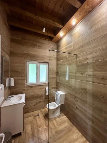 a bathroom with a toilet and a sink at Bianca Hotel & Villa in Tirana