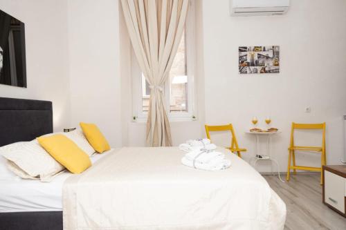 a bedroom with a bed with towels on it at Heart of Dubrovnik Old Town apartments in Dubrovnik