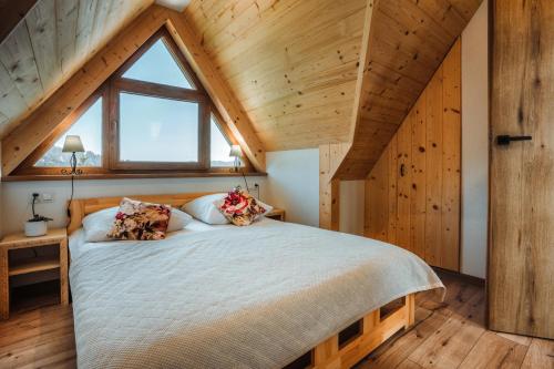 a bedroom with a large bed in a attic at Apartamenty Widok Tatr in Zakopane