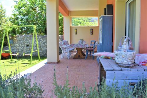 a patio with a table and chairs in a yard at Villa Niki in Págoi