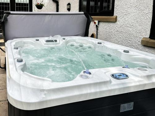 a jacuzzi bathtub with water in it at Castlebar in Little Singleton