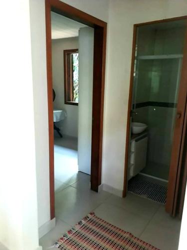 a bathroom with a walk in shower and a glass door at Casa da Floresta in Paraty
