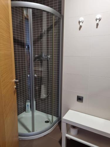 a shower with a glass door in a bathroom at Casa As Neves - 1B Gran Ventanal in Malpica