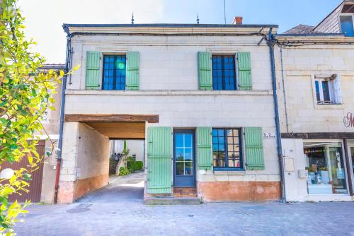 an old building with green doors and windows at Gîte Monkey cottage in Bouchemaine