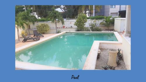 a large swimming pool in a yard with at Dos Casitas Tranquilo in Progreso