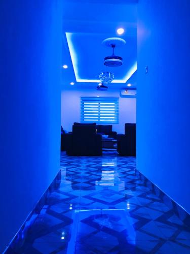a living room with blue lights and a blue ceiling at Mavern House Apartments in Elmina