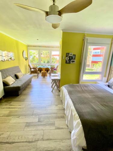 a bedroom with a bed and a living room at Estudio Sol del Mar in Torrox