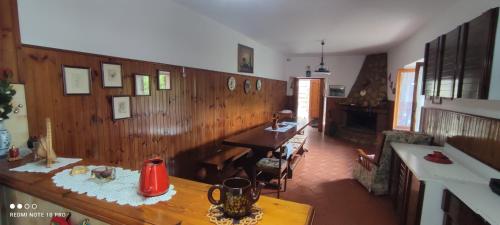 a living room with wooden walls and a table at Casa Belvedere a Valle San Martino di Spoleto in Spoleto