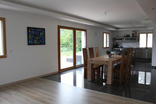 a kitchen and dining room with a table and chairs at Chez Lily et Bruno in Morbier