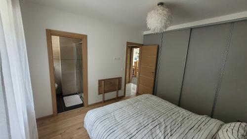 a bedroom with a bed and a large mirror at Chez Lily et Bruno in Morbier