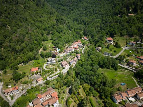 an aerial view of a house in a forest at La casa sotto le cascate Lago Maggiore - IXIHOME in Cittiglio