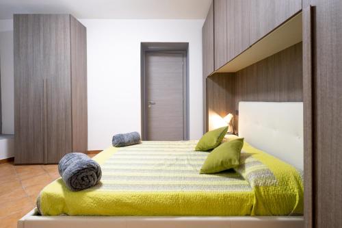 1 dormitorio con 1 cama grande con manta amarilla en La casa sotto le cascate Lago Maggiore - IXIHOME, en Cittiglio