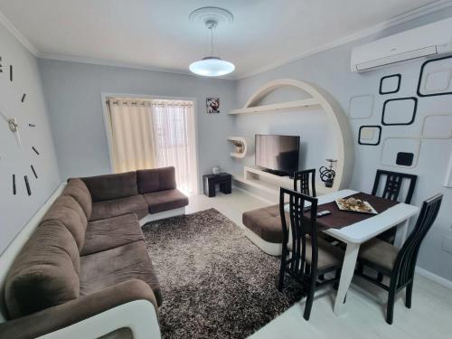 a living room with a couch and a table at Bala Apartment in Shkodër