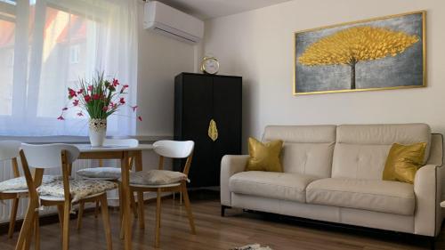 a living room with a couch and a table at Golden Apartament Legionów in Toruń